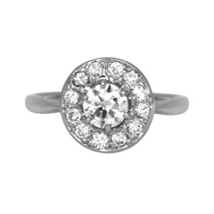 Vintage 14k white gold halo ring set with a 0.50 carat round brilliant earth-mined diamond plus 0.30 carats of round brilliant earth-mined diamonds.