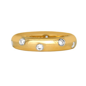 Vintage 18k yellow gold and platinum Tiffany & Co. Etoile Band set with 0.20 carats of round brilliant earth-mined diamonds.