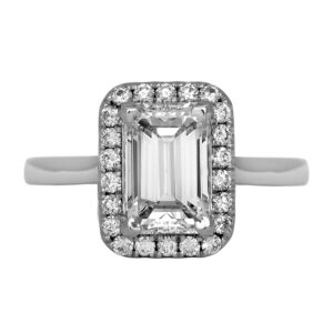 Vintage 18k white gold halo engagement ring set with a 2.03 carat emerald cut earth-mined diamond plus 0.25 carats of round brilliant earth-mined diamonds.
