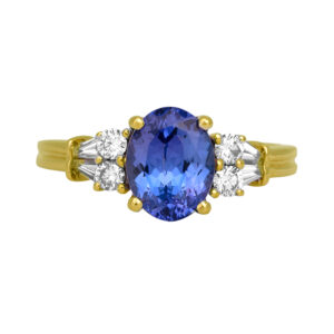 Vintage 14k yellow gold ring set with a 1.89 carat oval tanzanite plus 0.25 carats of round brilliant and baguette earth-mined diamonds.