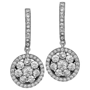 Vintage 18k white gold halo earrings set with 1.39 carats of round brilliant earth-mined diamonds.