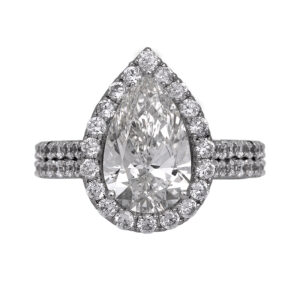 Vintage 14k white gold engagement ring set with a 3.67 carat lab-grown pear diamond plus 1.74 carats of round brilliant earth-mined diamonds in the halo and band.