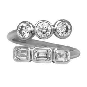 New 14k white gold bypass ring set with 1.90 carats of round brilliant and emerald cut lab-grown diamonds.