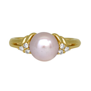 Vintage 14k yellow gold ring set with a pearl plus 0.10 carats of round brilliant earth-mined diamonds.