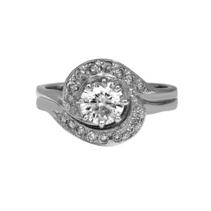 Vintage 18k white gold halo ring set with a 0.69 carat round brilliant earth-mined diamond plus 0.34 carats of round brilliant earth-mined diamonds.