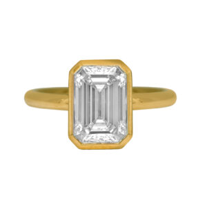 New 14k yellow gold solitaire engagement ring set with a 3.63 carat emerald cut lab-grown diamond.