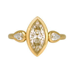New 14k yellow gold three stone engagement ring set with a 2.01 carat marquise lab-grown diamond plus 0.41 carats of pear lab-grown diamonds.